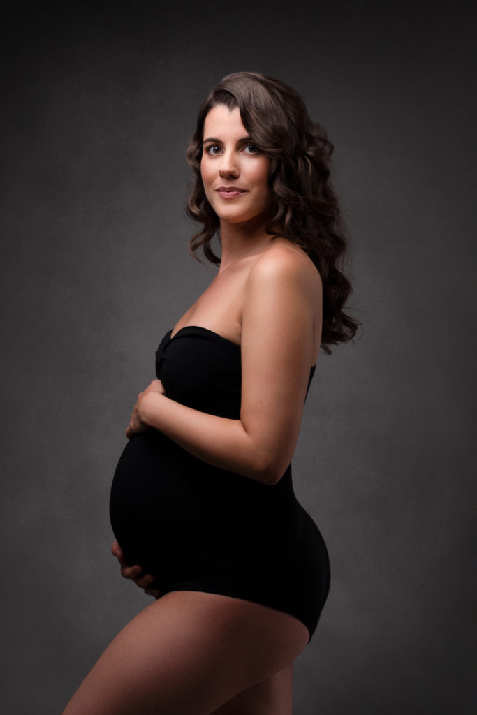 Femme enceinte, de profil, dans un body noir